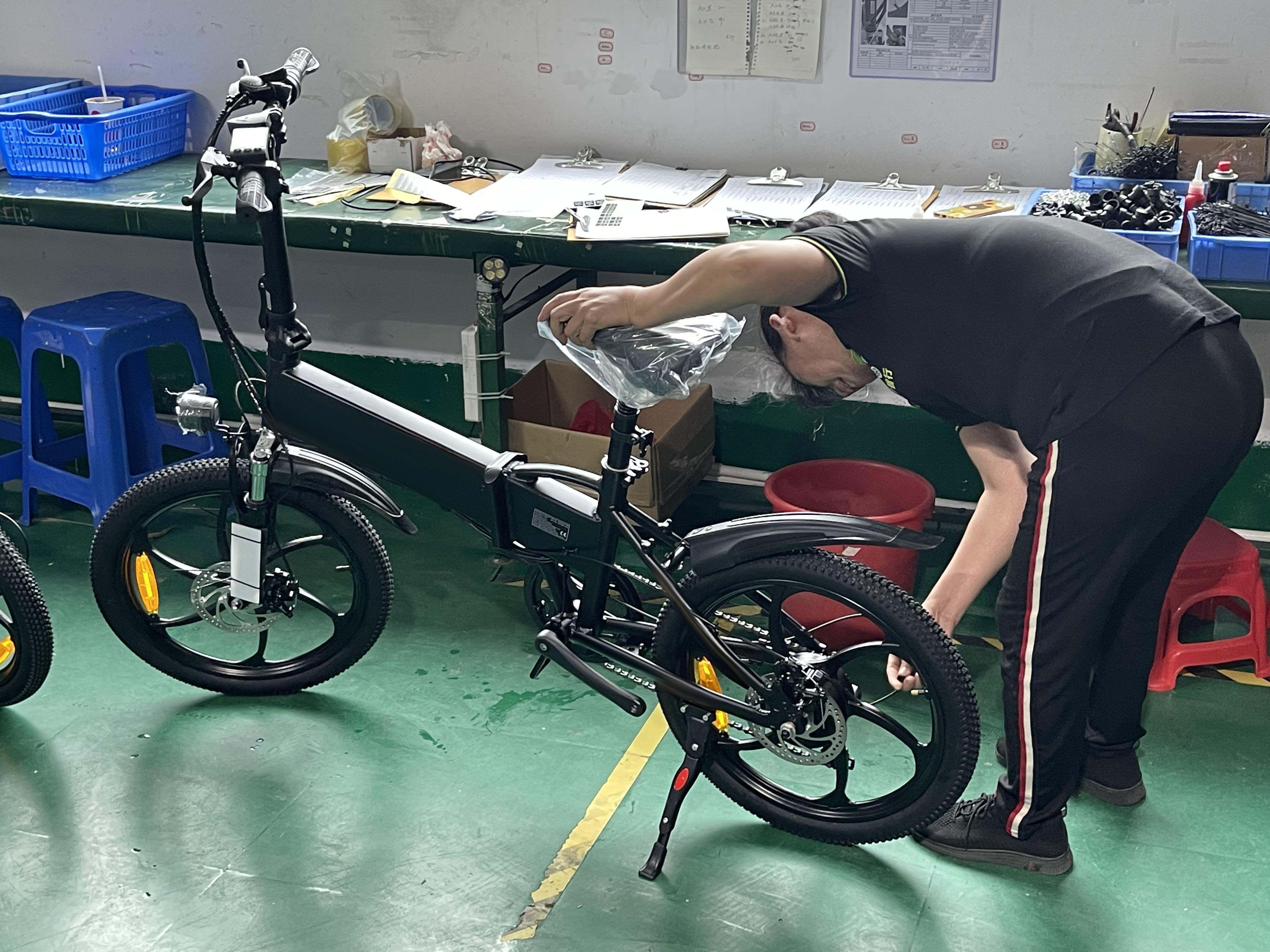 Workers check electric bicycles